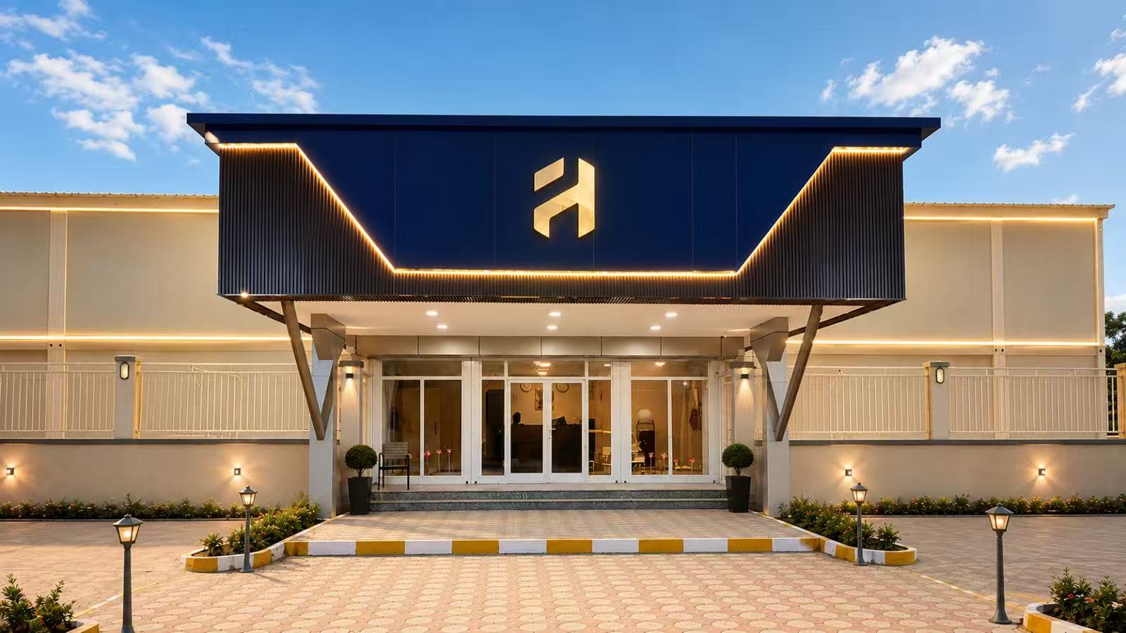 Flora Hotel entrance with illuminated canopy and glazed doors